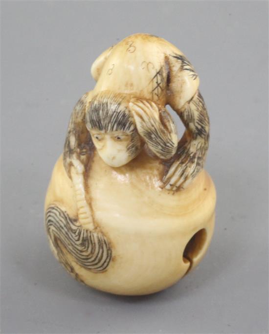 A Japanese ivory netsuke, carved with a monkey crouching on a bell, late 19th/early 20th century 4.3cm